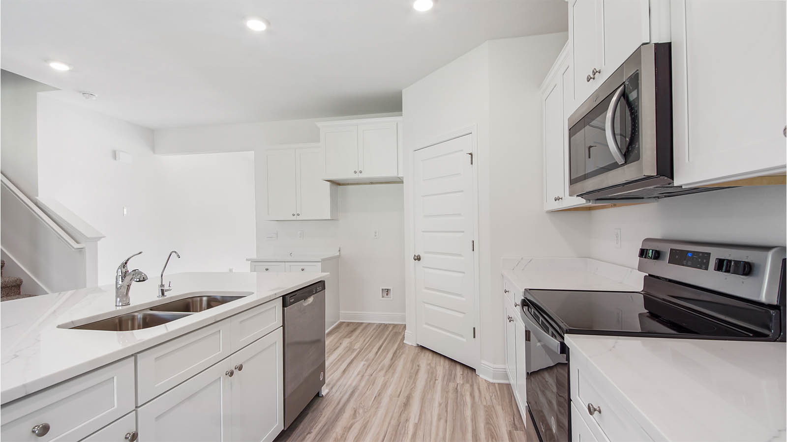 Kitchen island with quartz countertops and dishwasher and sink.