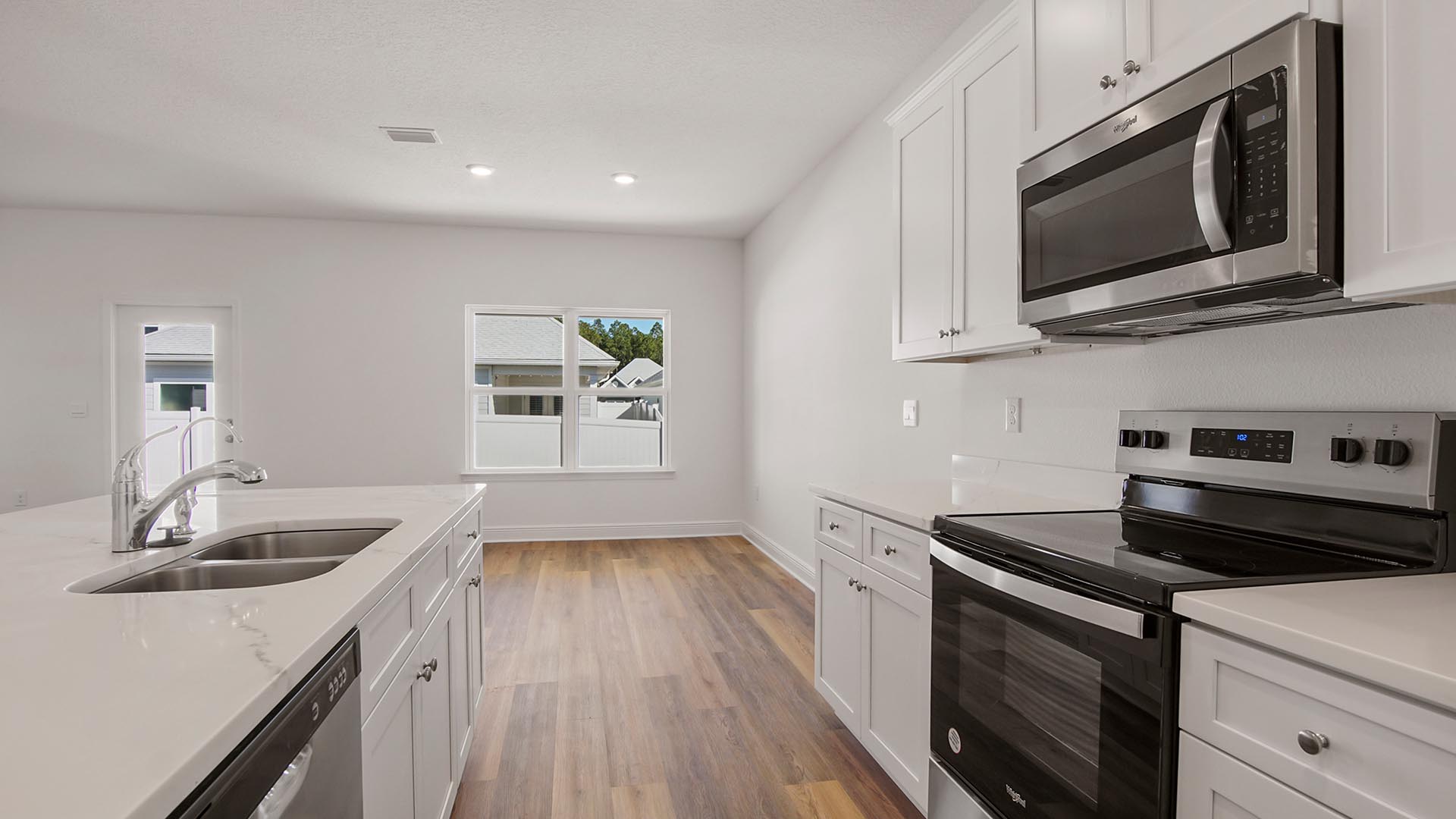 The kitchen has an appliance package that includes a stove, microwave and dishwasher