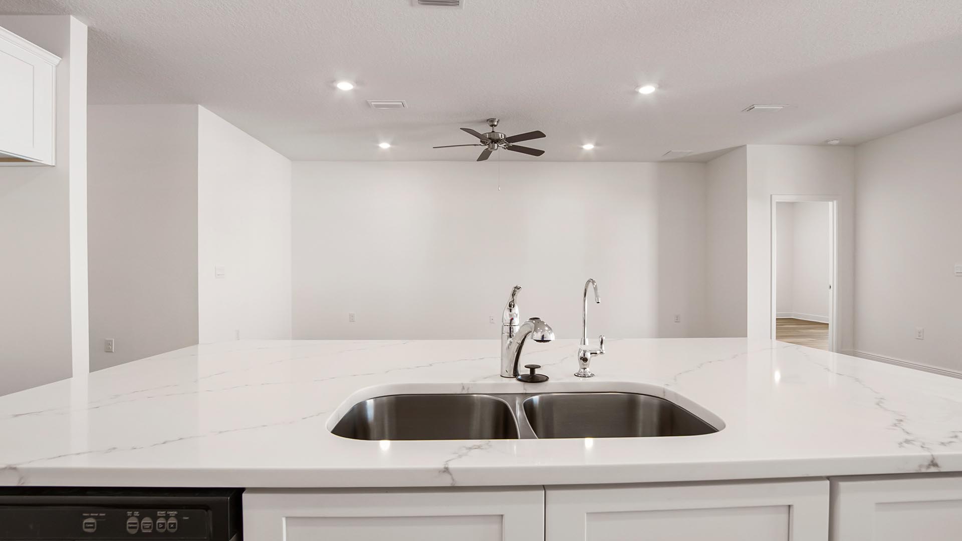The kitchen island holds the sink and dishwasher for easy meal prep and cleanup