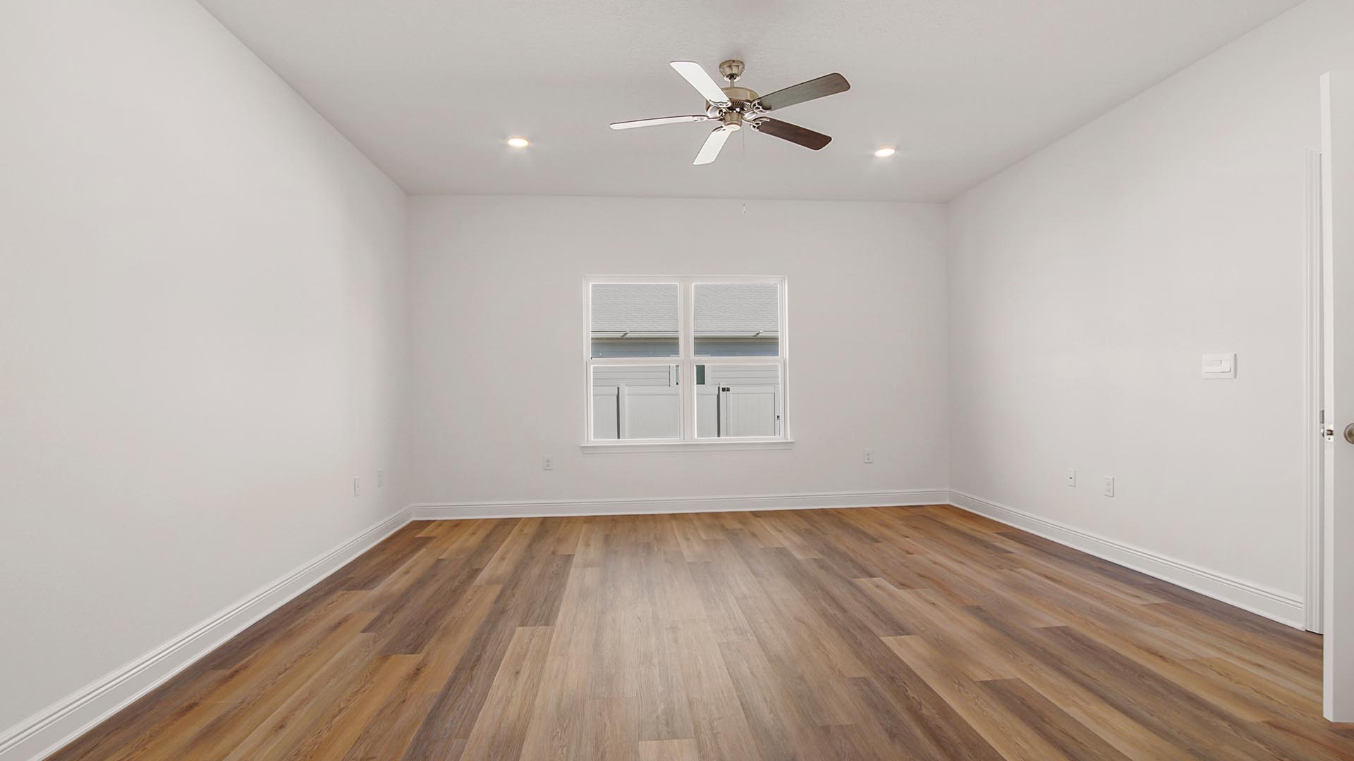 The primary bedroom has EVP flooring and a ceiling fan