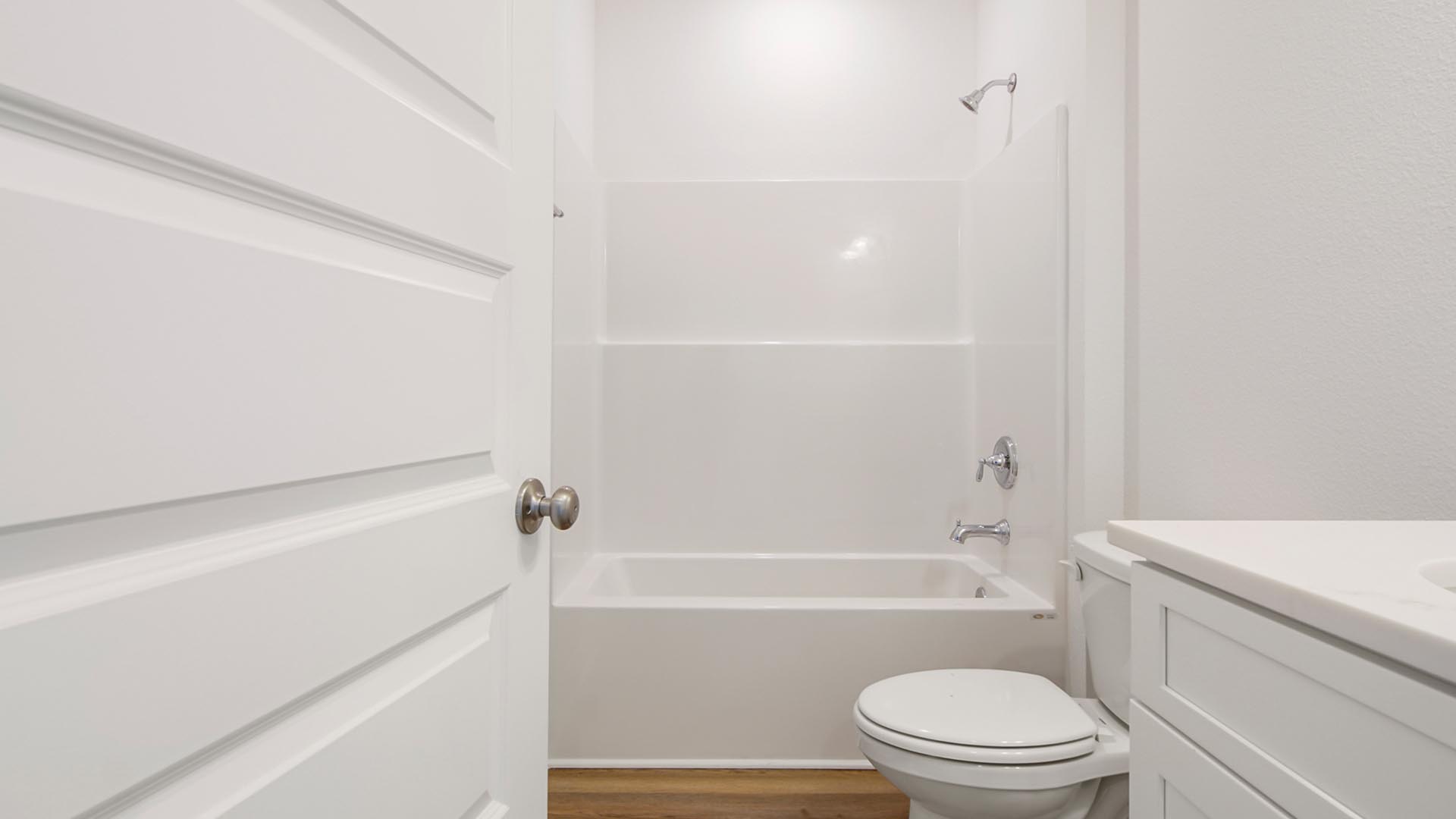 The shared bathroom has a shower tub combination