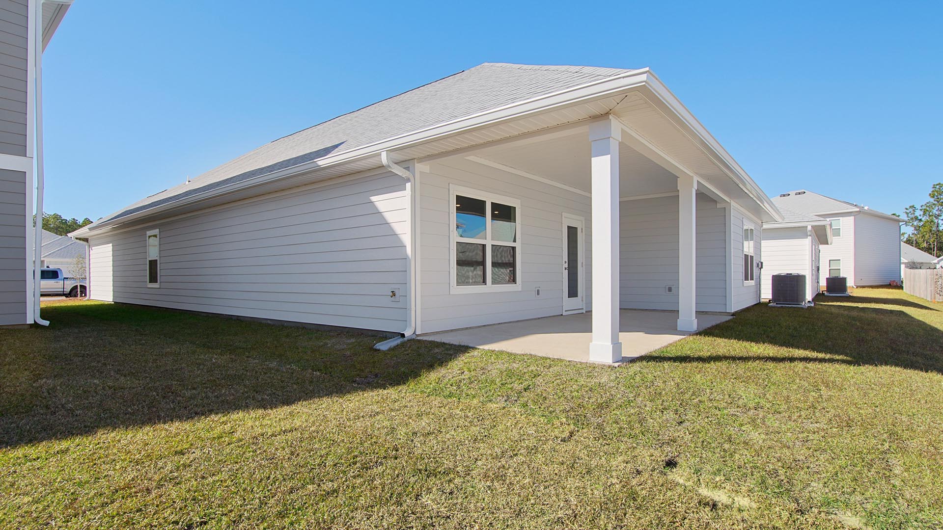 The back of the home has a covered patio