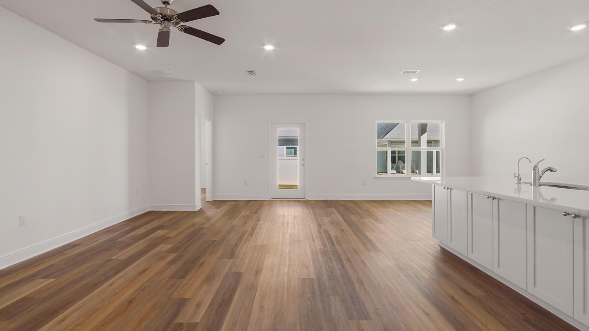 The open concept living area and kitchen has EVP flooring