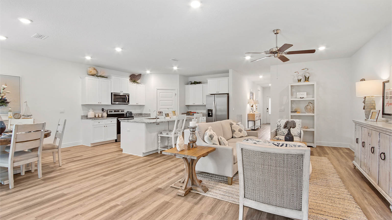 Grand living area with dining area and kitchen with EVP flooring and corner walk in pantry.