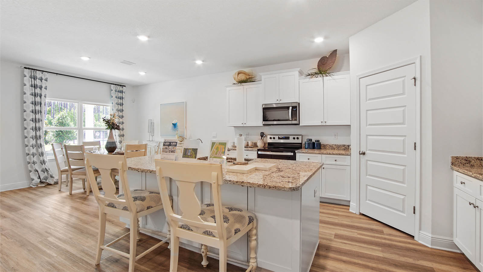 Kitchen and dining area with large window and EVP flooring.