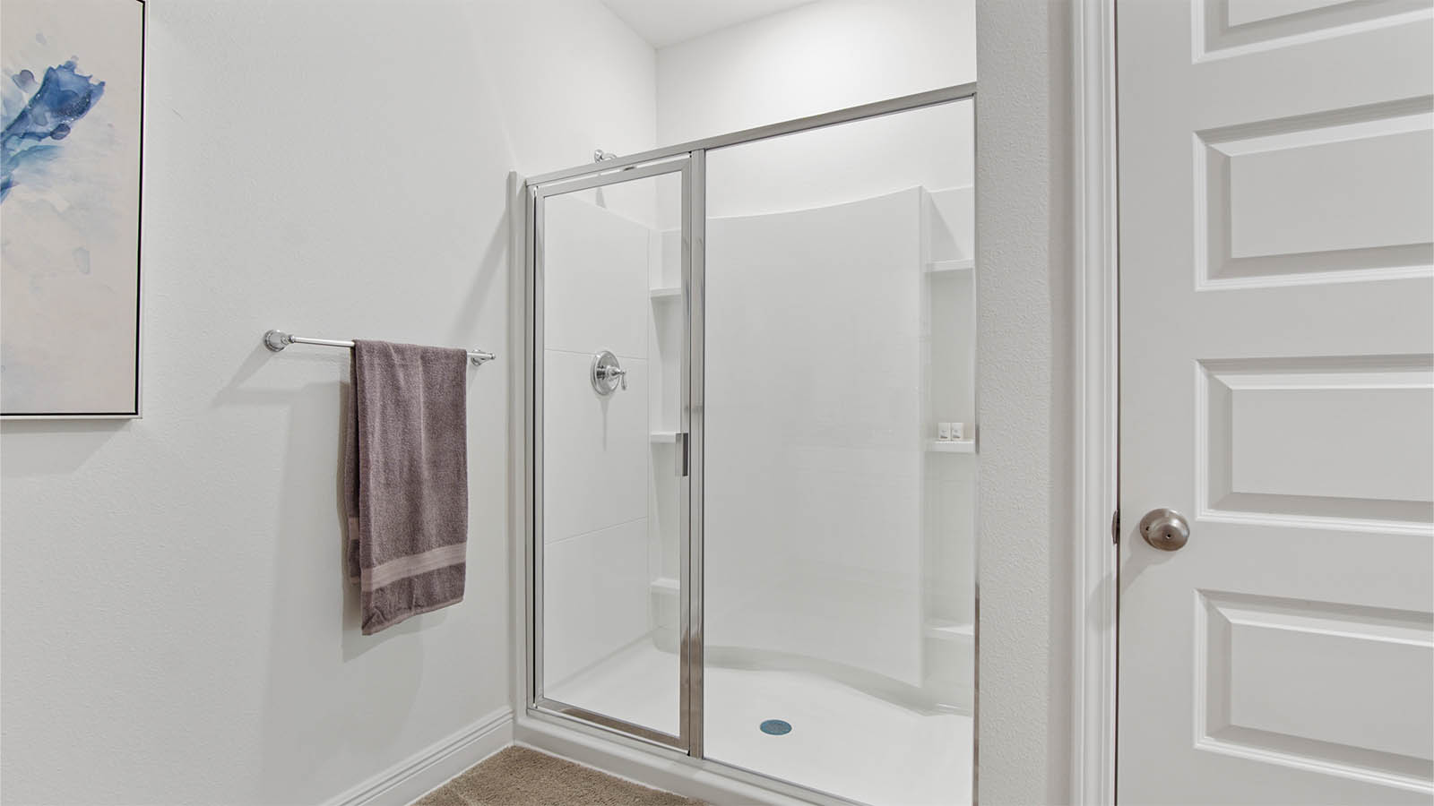 Primary bathroom with large standing shower next to water closet.