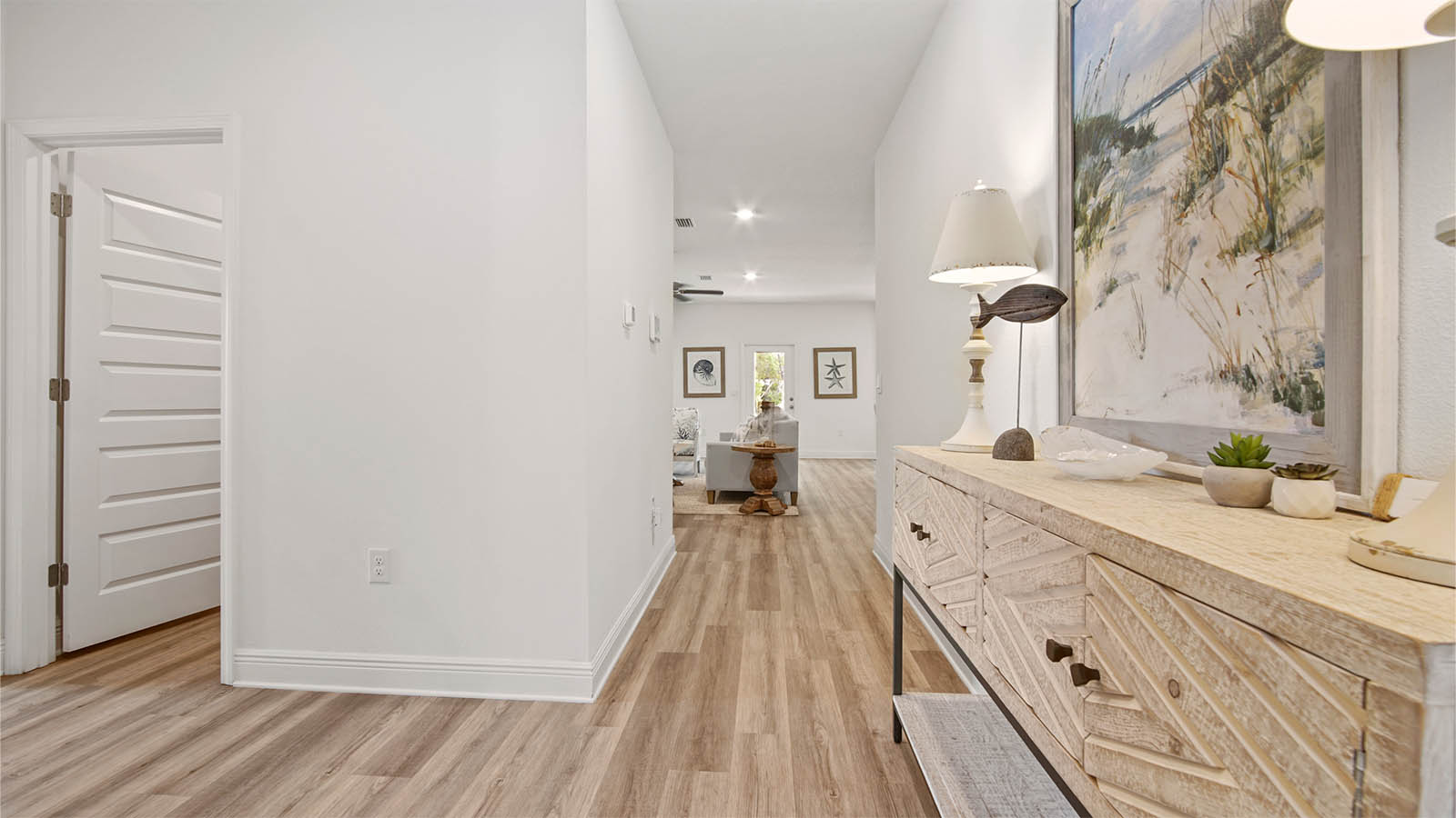 Foyer with second hallway to laundry room and a guest bedroom.