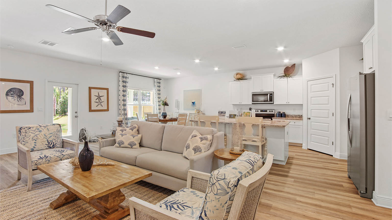 Open living area with EVP flooring and kitchen island with bar seating.