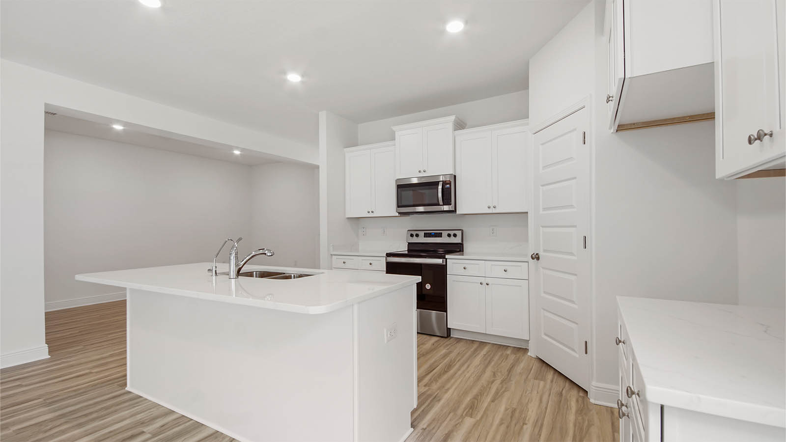 The kitchen has upper and lower cabinetry for storage
