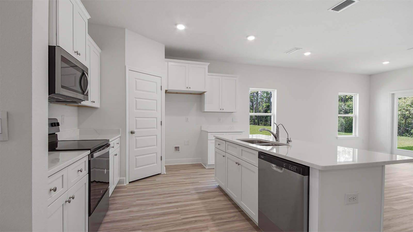 The kitchen has an appliance package that includes a stove, microwave and dishwasher