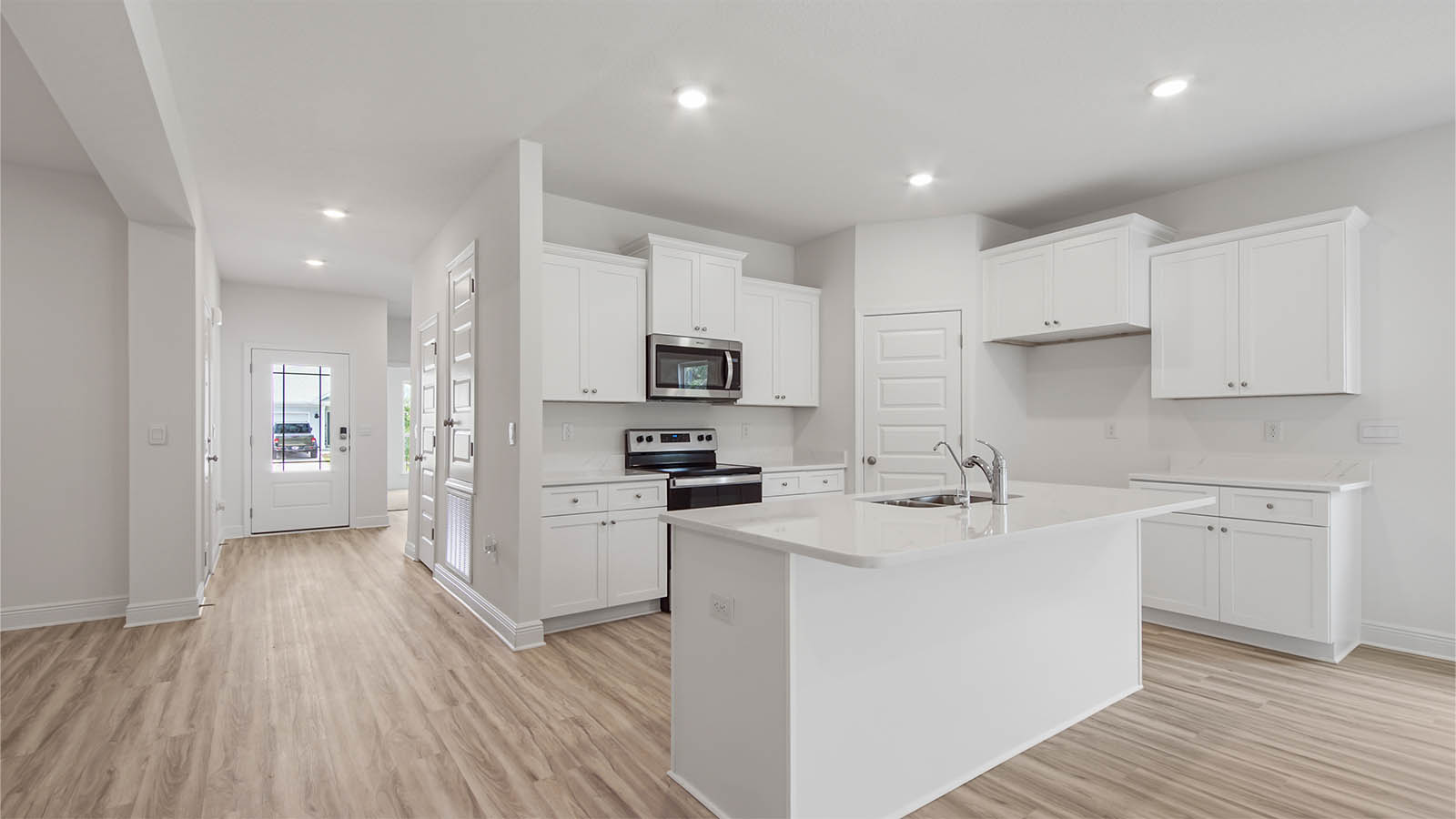 The open kitchen has an island with space for bar seating
