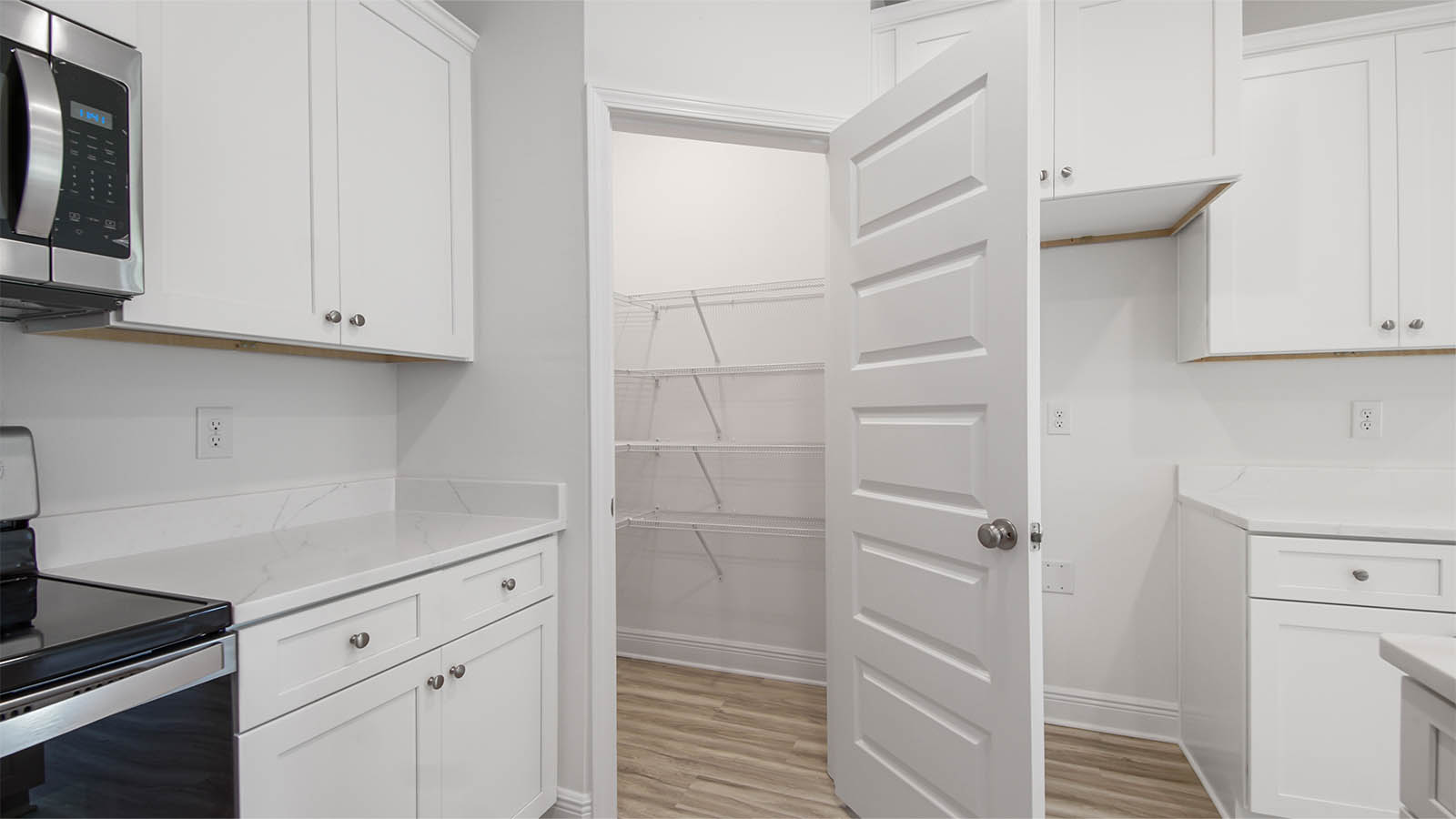 The corner pantry has shelving for storage of dry good or small appliances