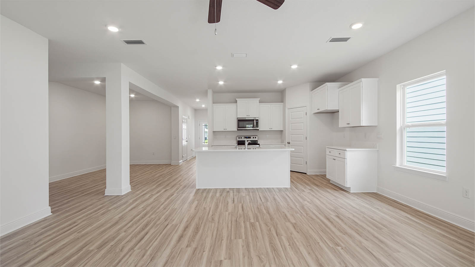 The open living room has an expanse of windows that allow for natural light