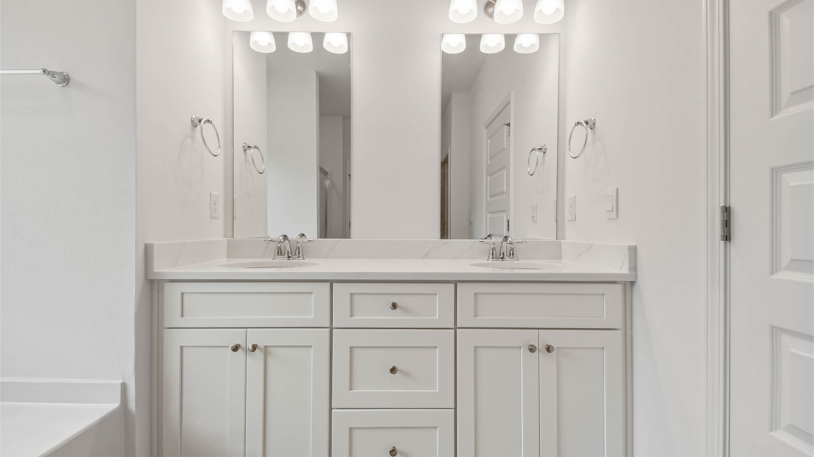 The primary bathroom has lower cabinetry for storage and a dual sink vanity