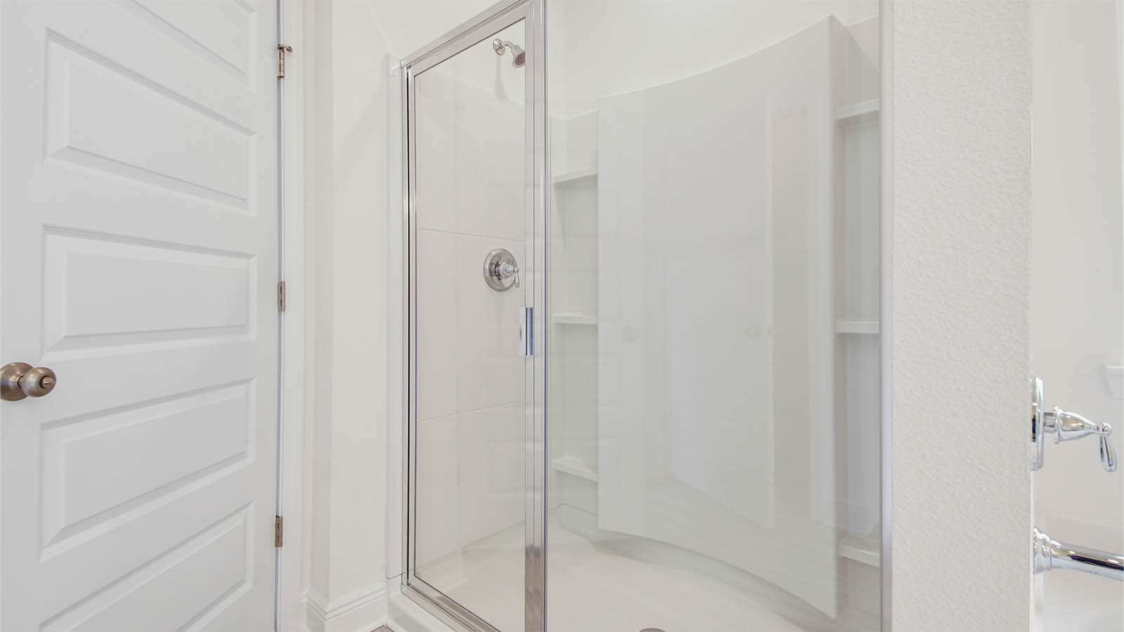 The shower has a glass enclosure