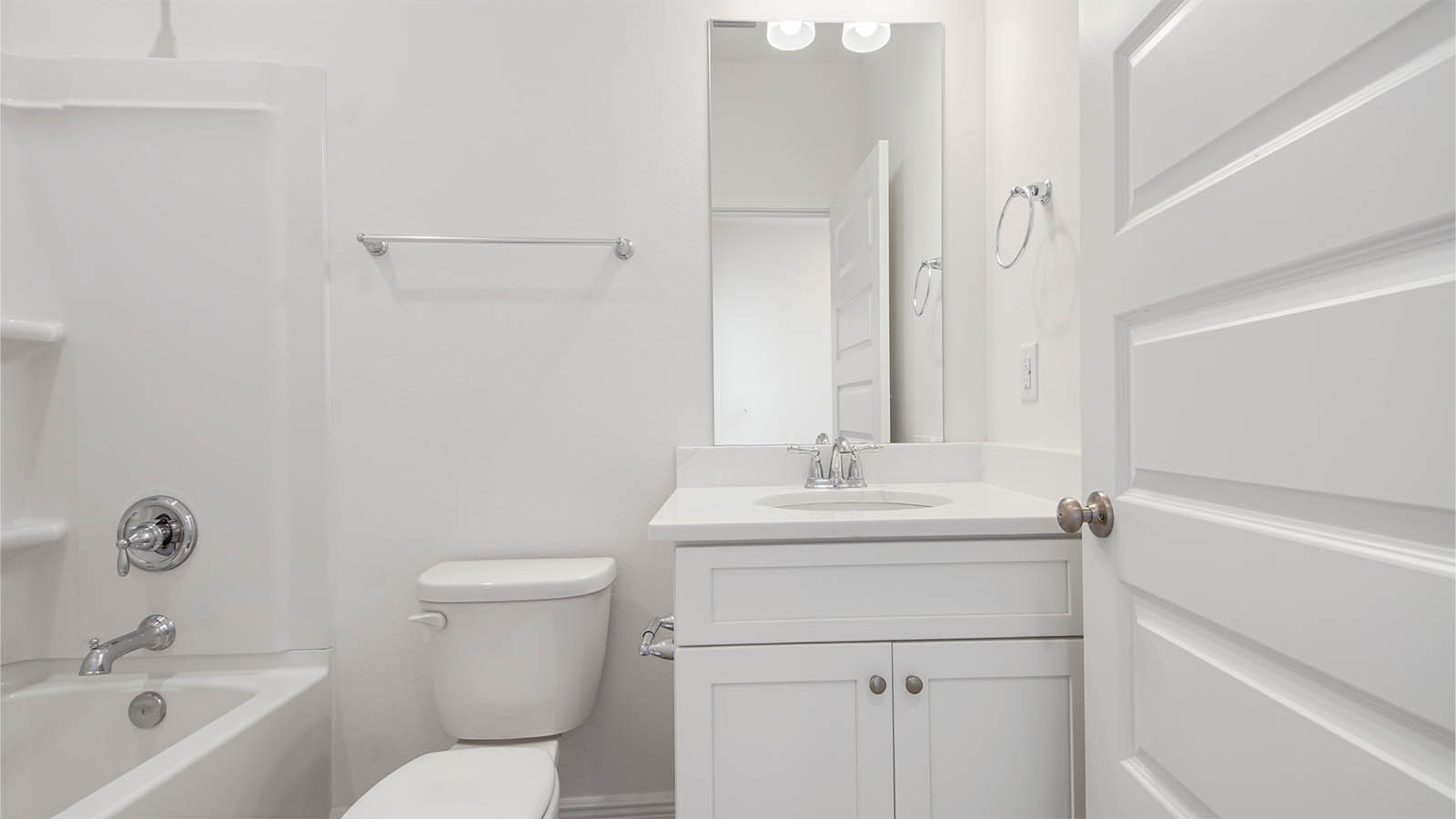 The shared bathroom has a single vanity with lower cabinetry