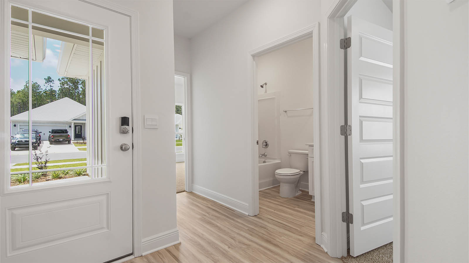 Bright entry of the Kennedy floor plan and two bedrooms off the entry hall