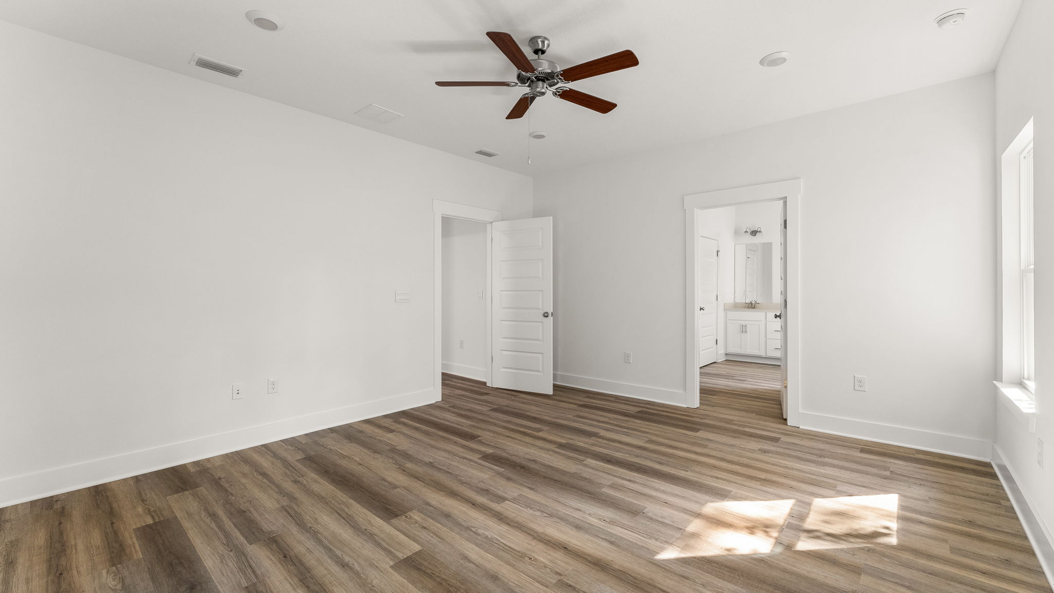 The primary bedroom has EVP flooring