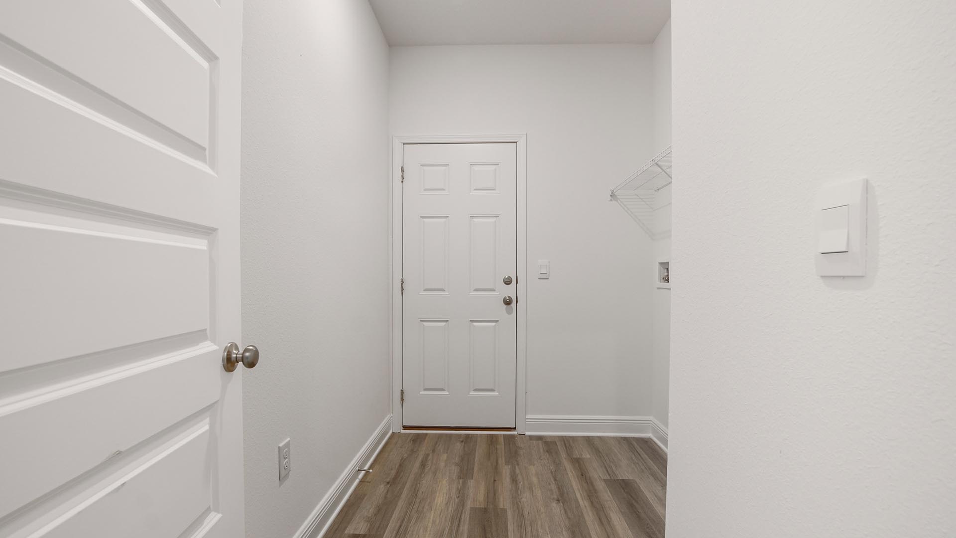 The laundry area is located close to bedrooms two and three