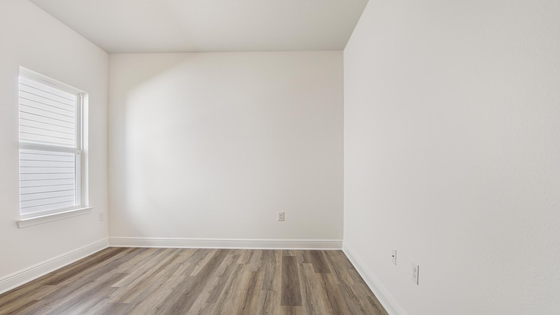 Bedroom two with a window and carpeted flooring.