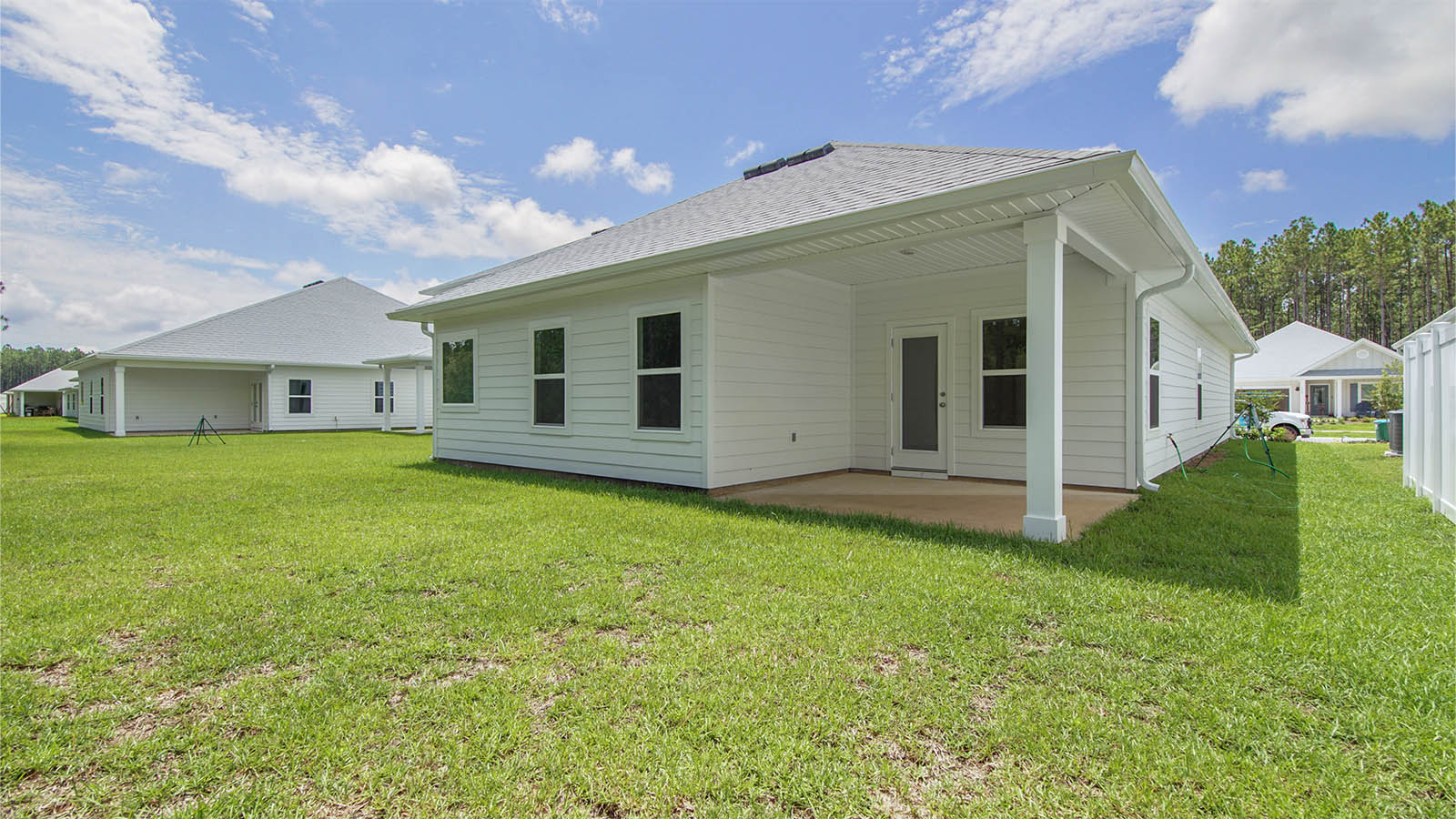 The back of the home has a covered patio