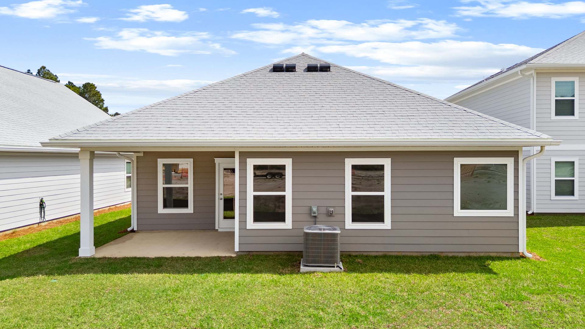 The back of the home has windows allowing for natural light