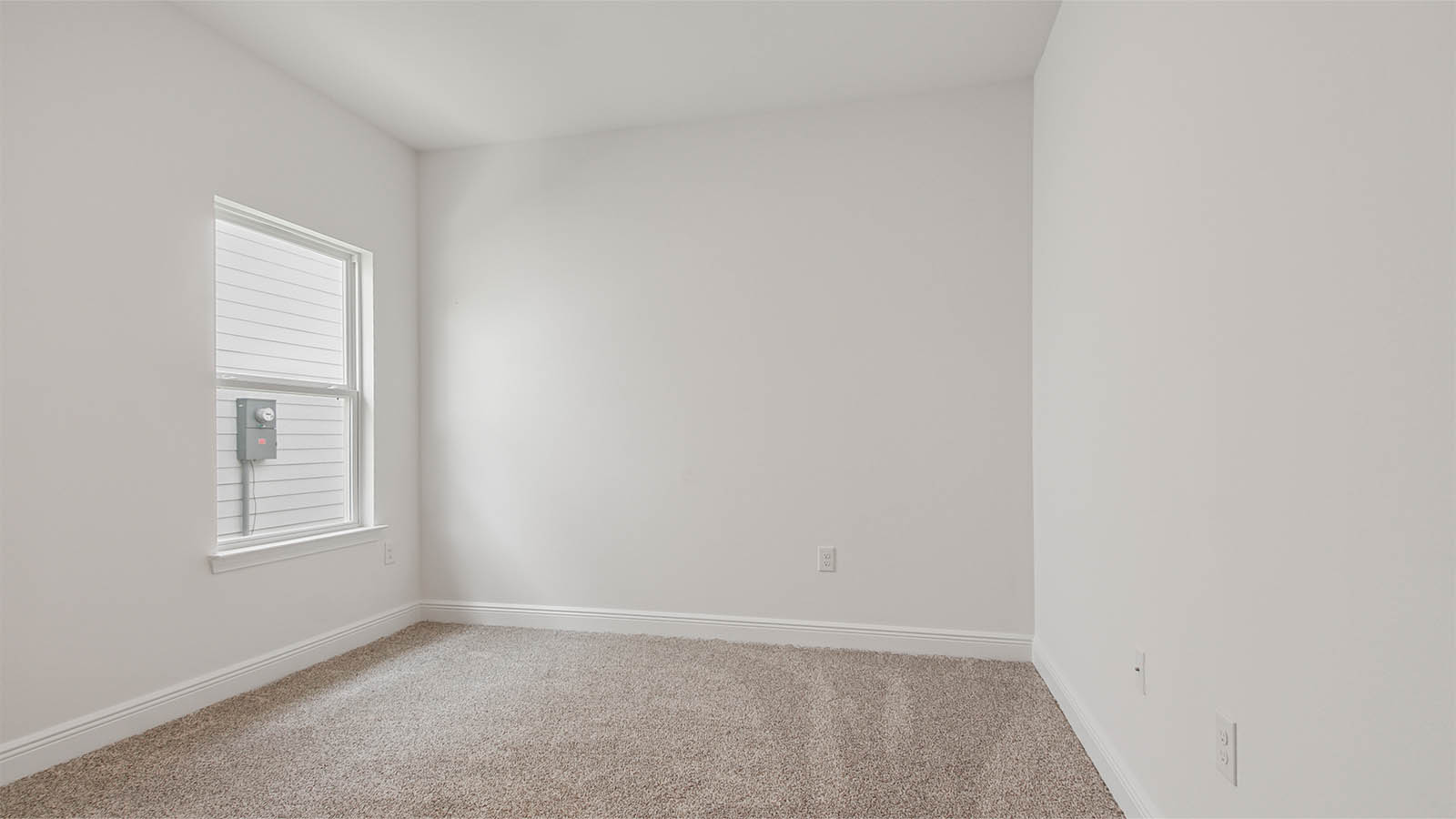 Bedroom three with a window and carpet flooring.