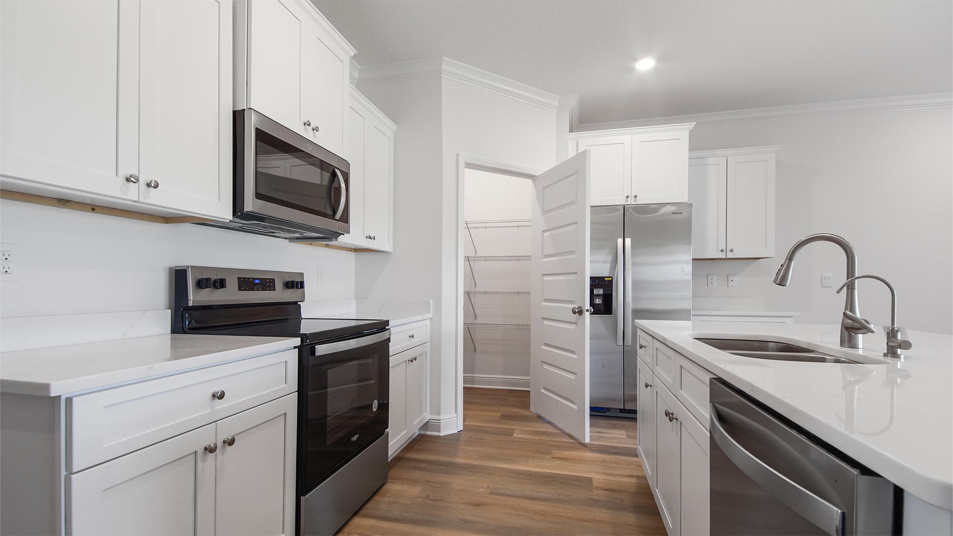 An appliance package is included with a stove microwave and dishwasher