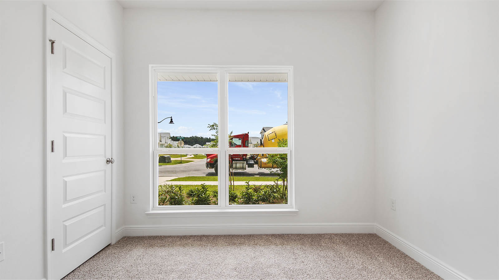 Additional bedroom with large picture wind is located at the front of the home