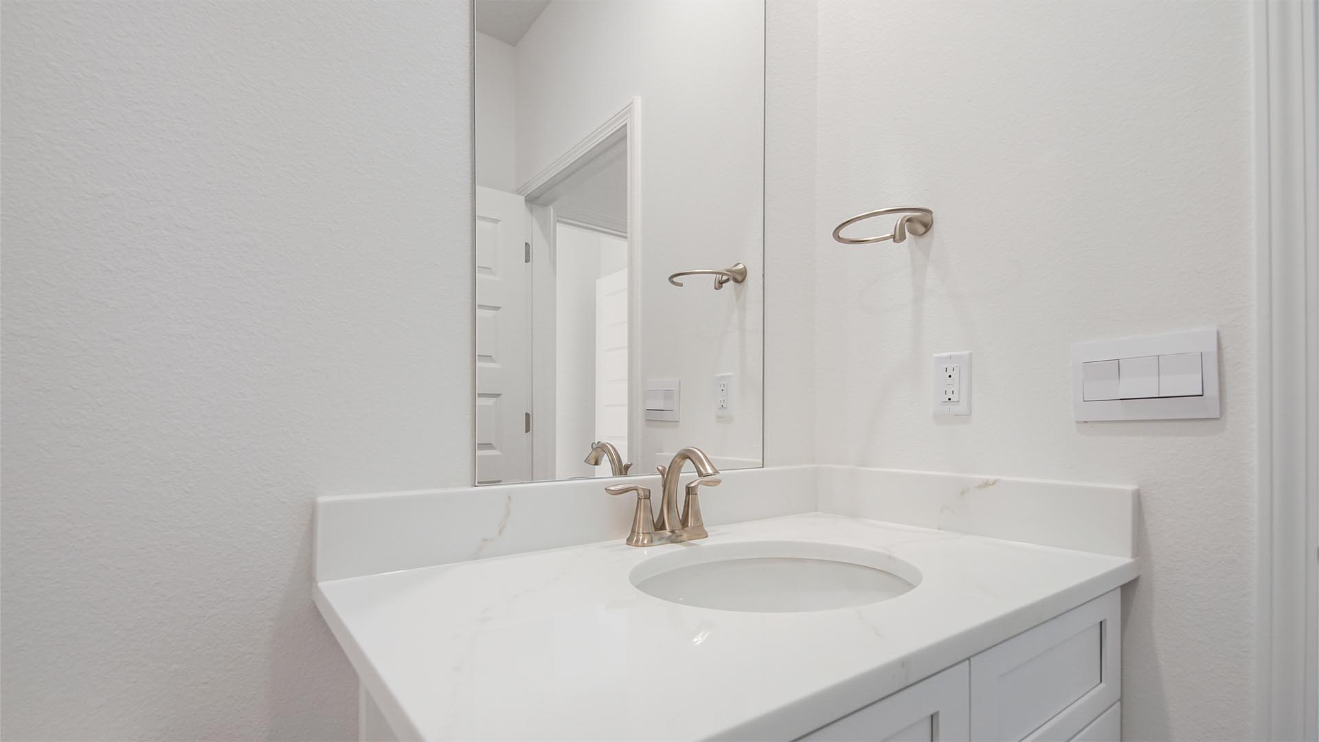 The single vanity has lower cabinetry for storage