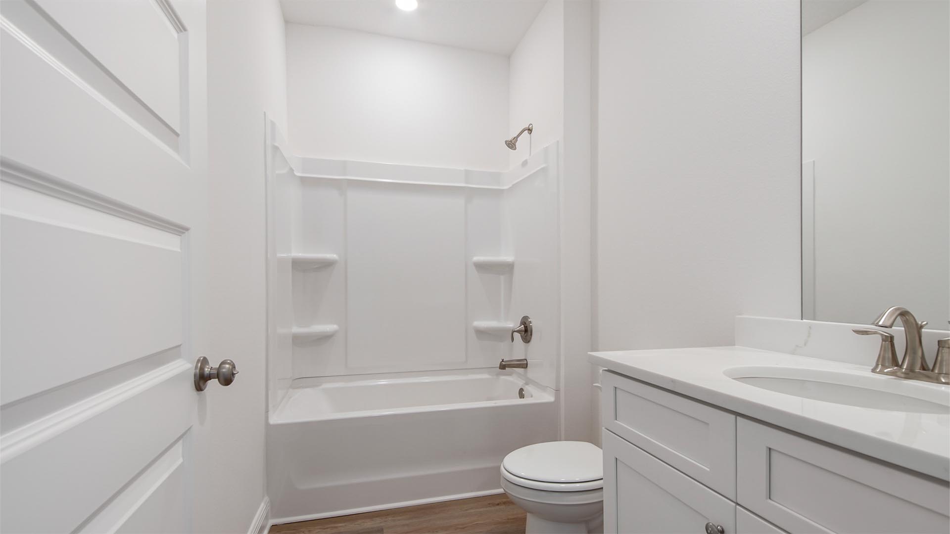 The shared bathroom features a shower tub combination and EVP flooring