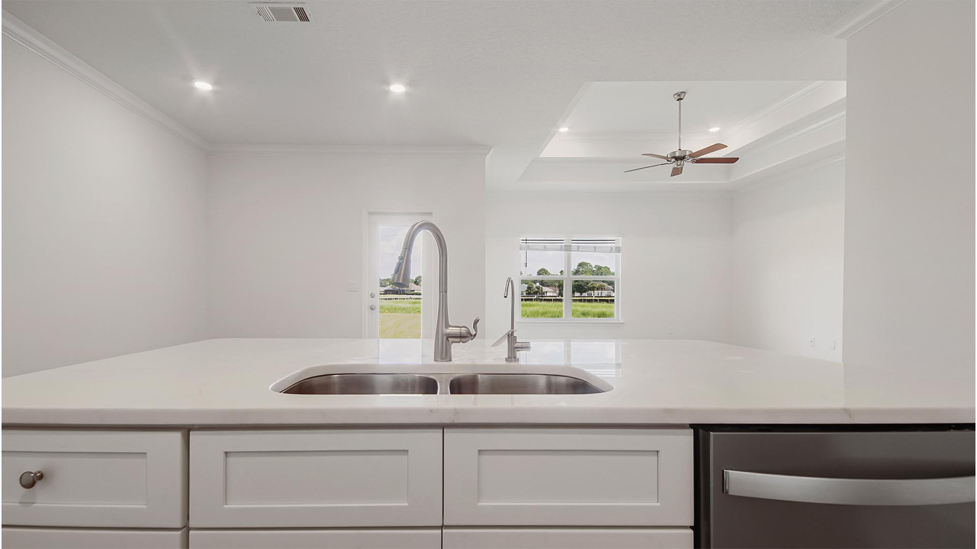 The kitchen island has a sink and dishwasher for easy meal prep service and clean up