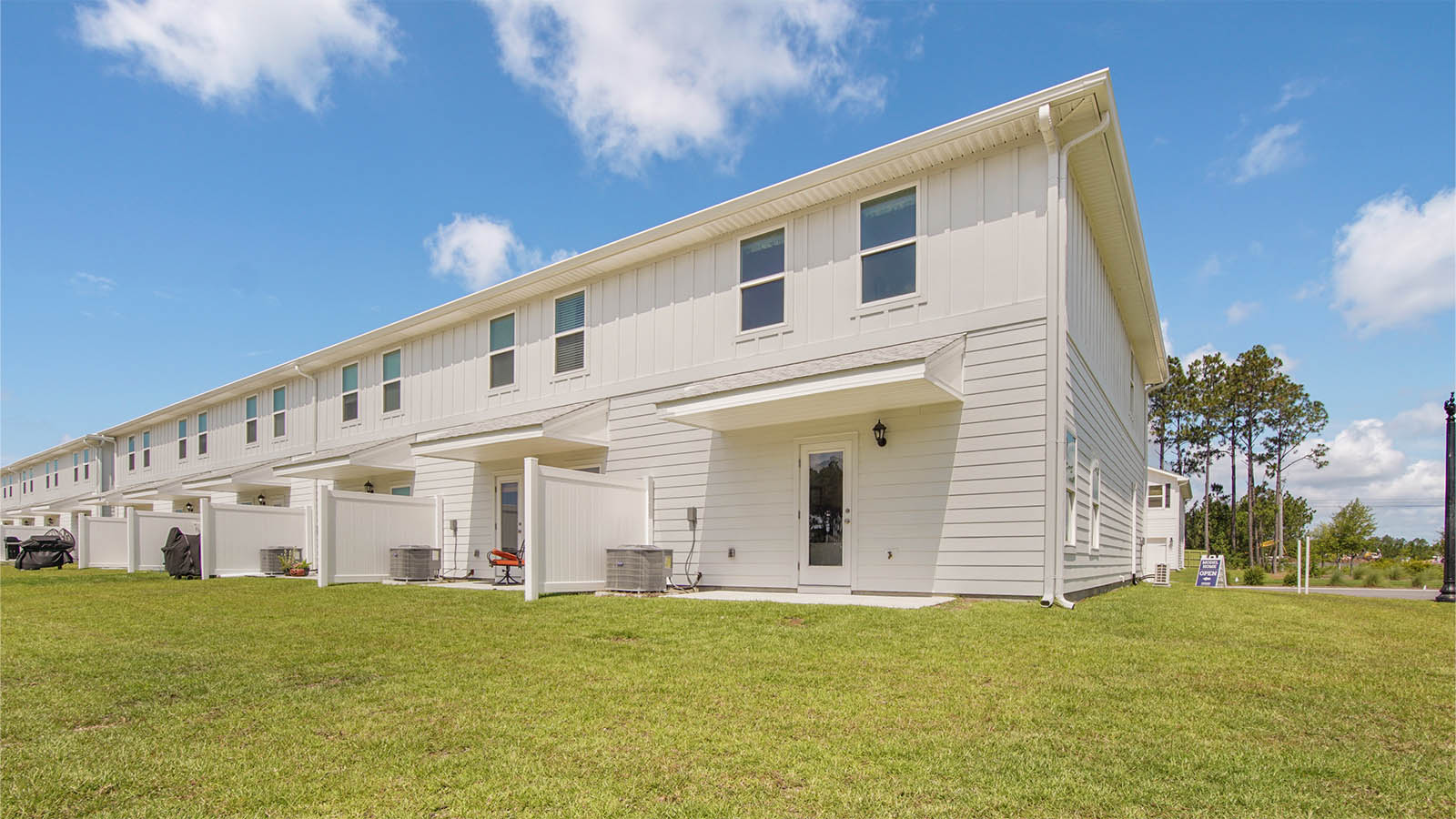 The back of the townhome has a patio and a partition between units
