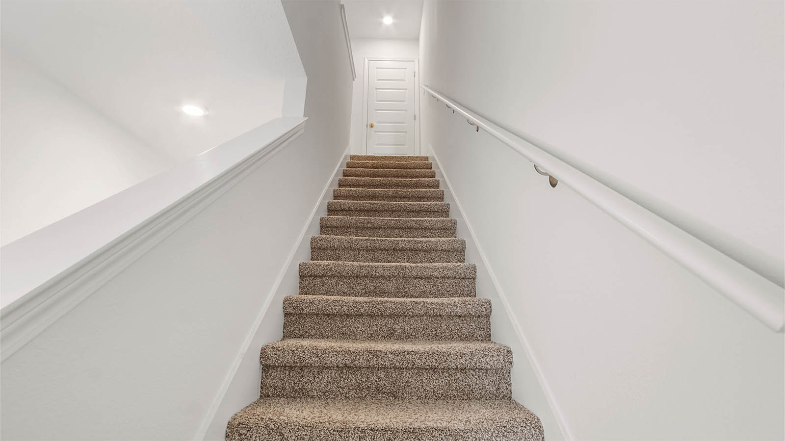 Carpeted stairs leading to all bedrooms on the second level