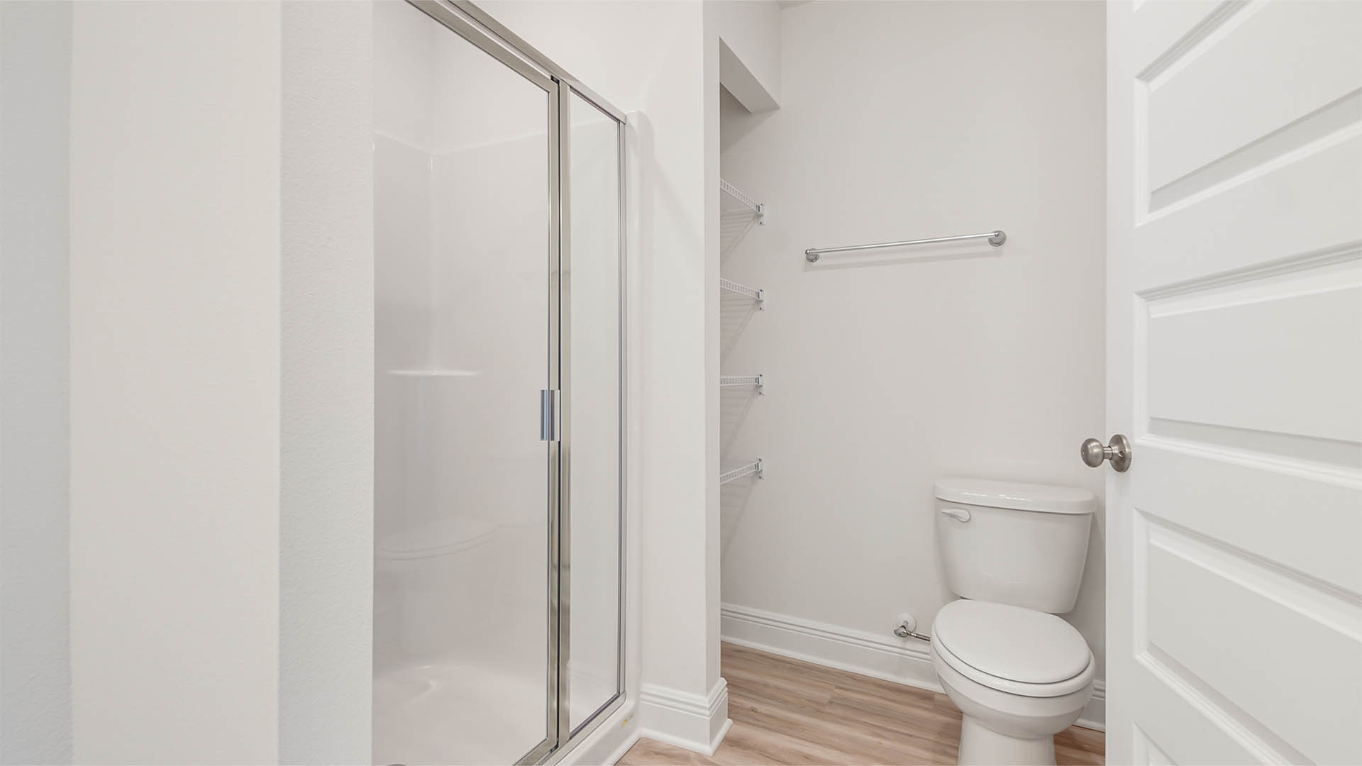 Primary bathroom shower with glass door enclosure