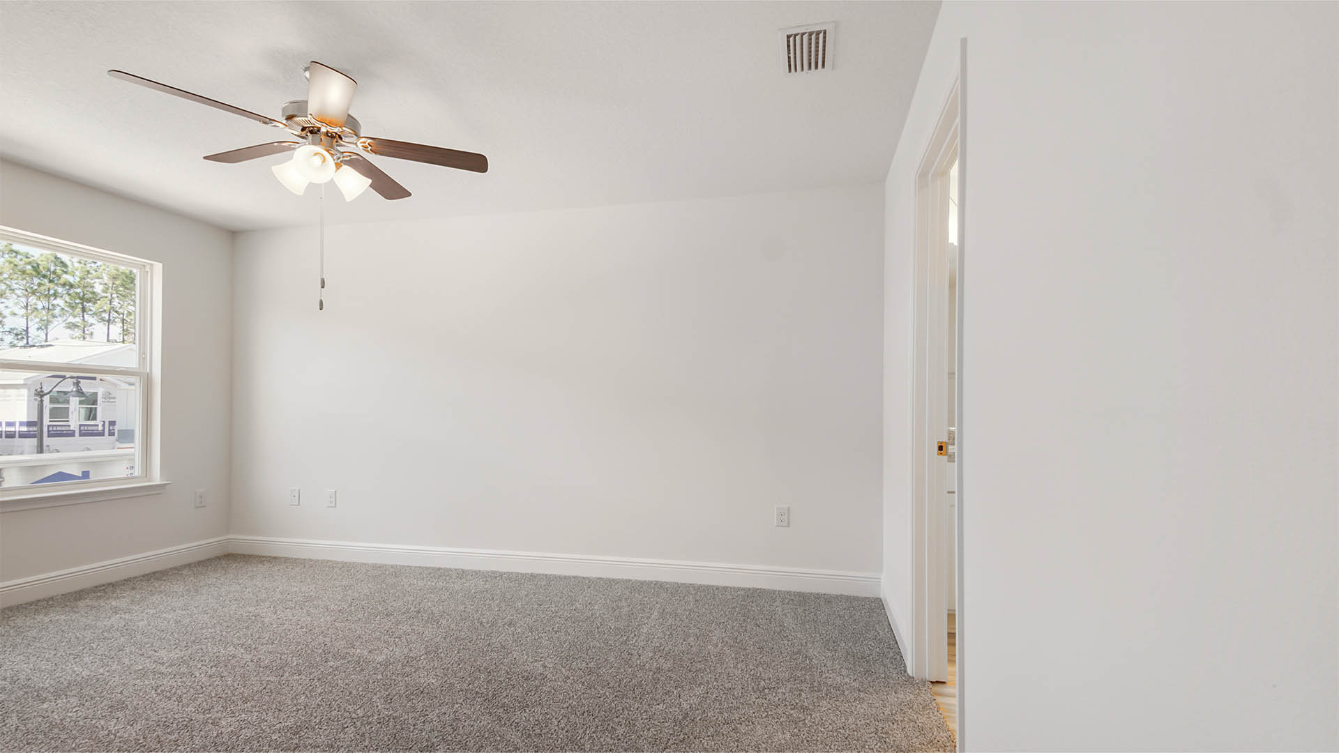 Primary bedroom with carpet and ceiling fan