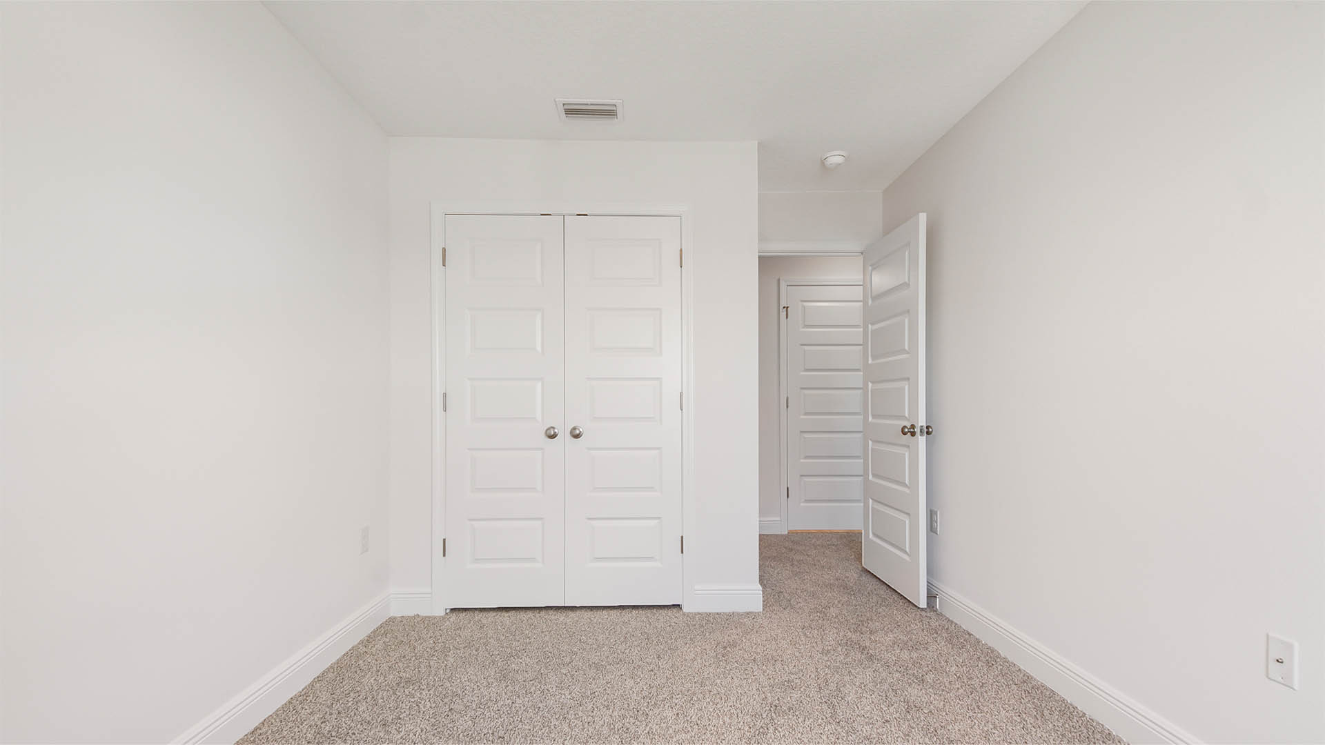 Bedroom 2 with closet space and plush carpet