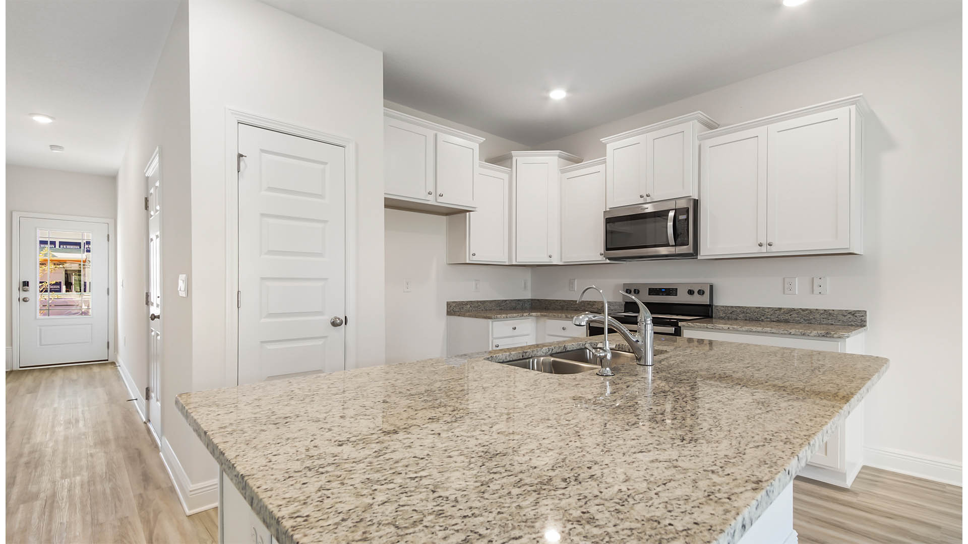 Kitchen with spacious center island and quartz countertops
