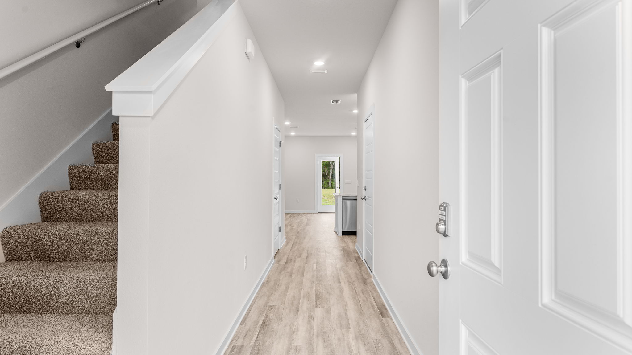 Entry hall with EVP flooring and carpeted stairs