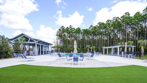 The community pool at Bayside at Ward Creek has lounge chairs, tables and a covered cabana