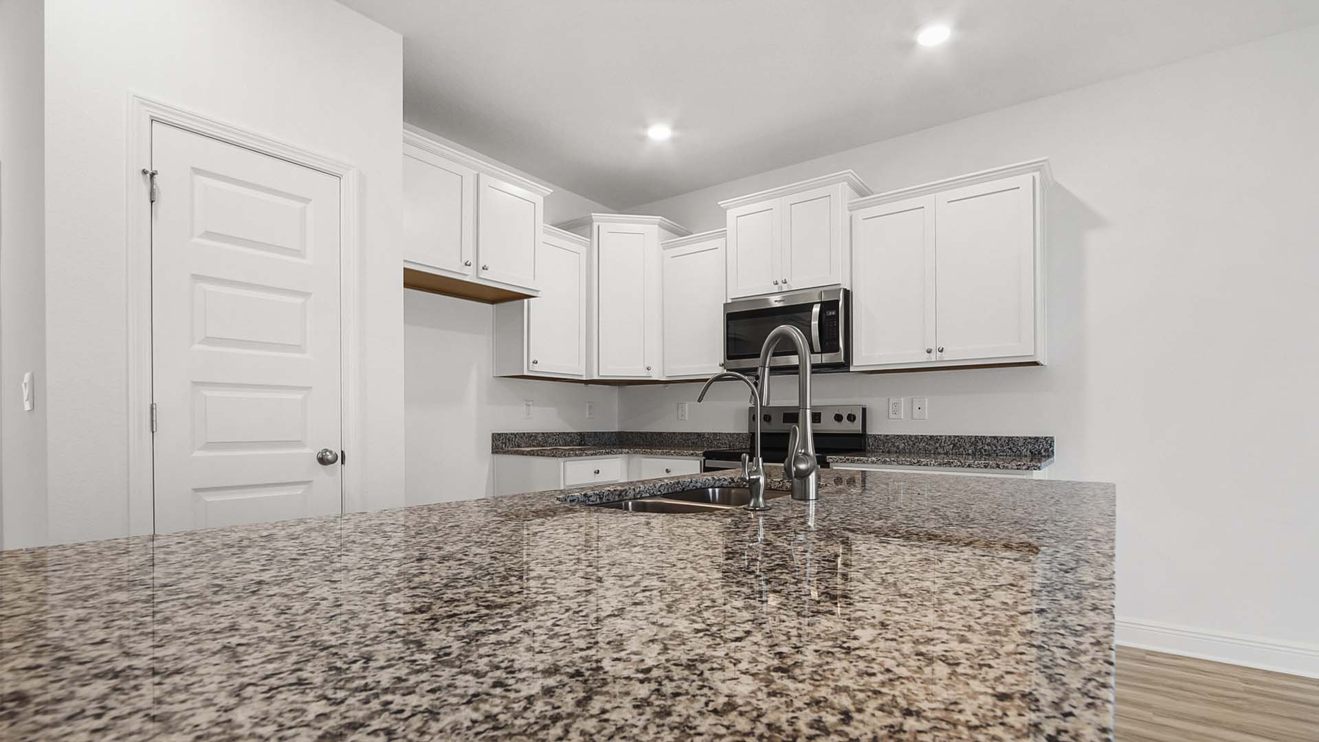The spacious island has a sink and dishwasher for easy meal prep and clean up