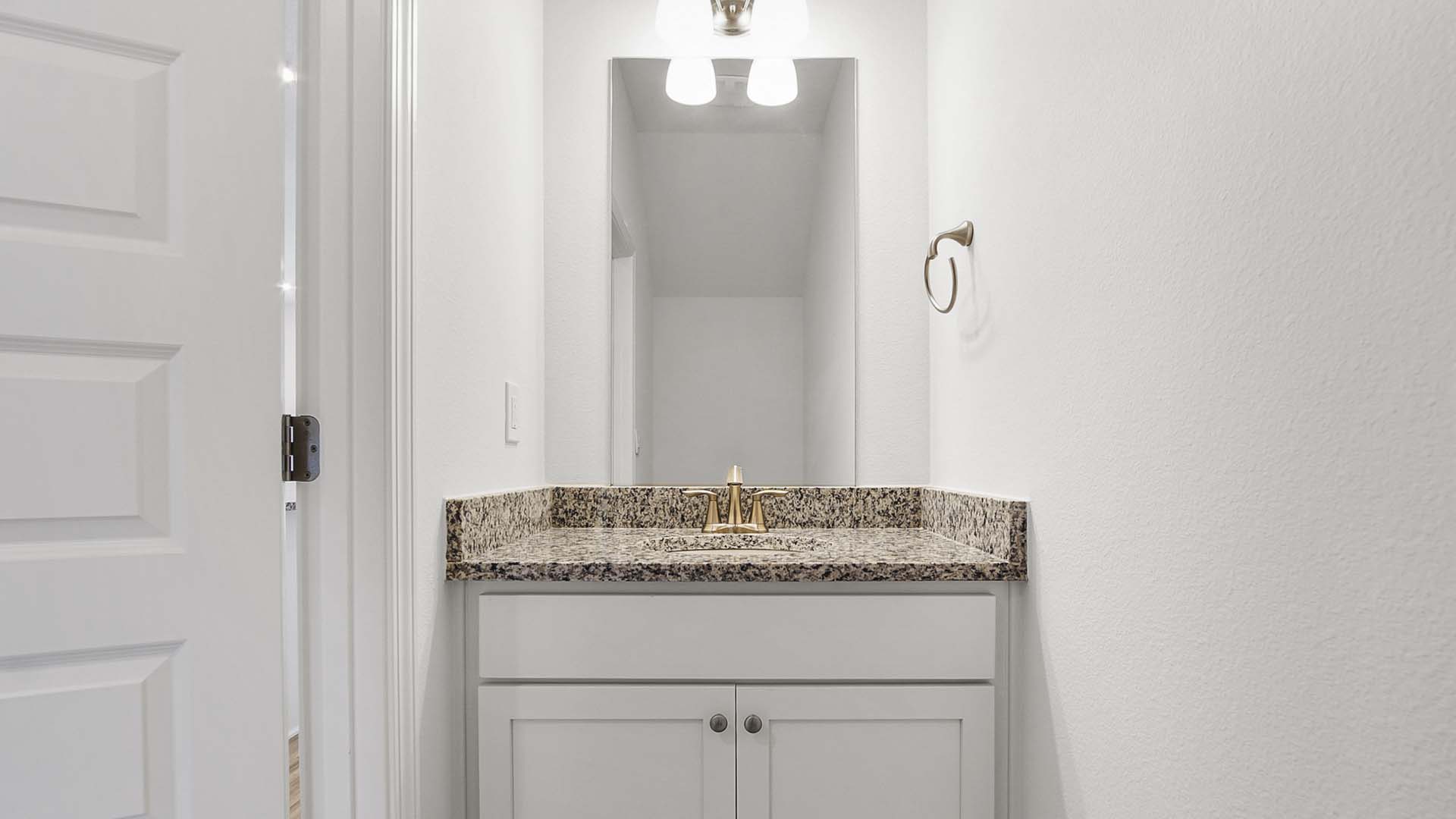 The half bath has granite counters