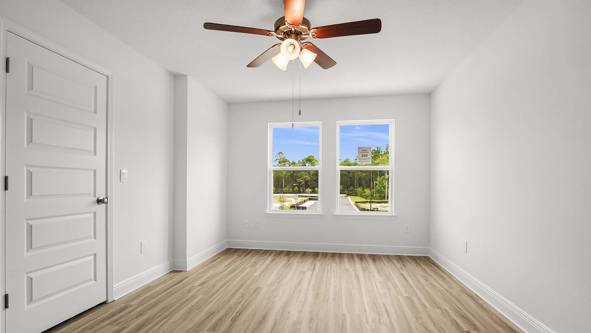 The primary bedroom has EVP flooring and an overhead fan