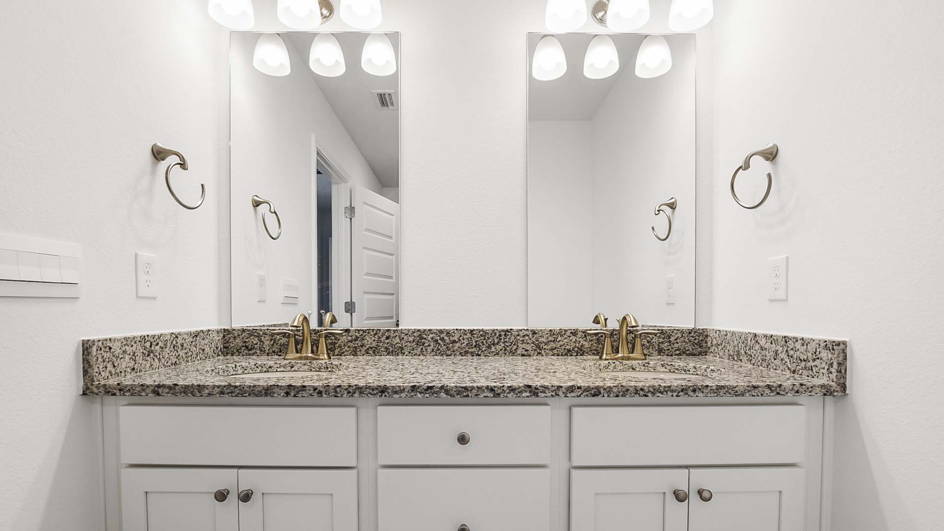 The countertops in the primary bath have granite