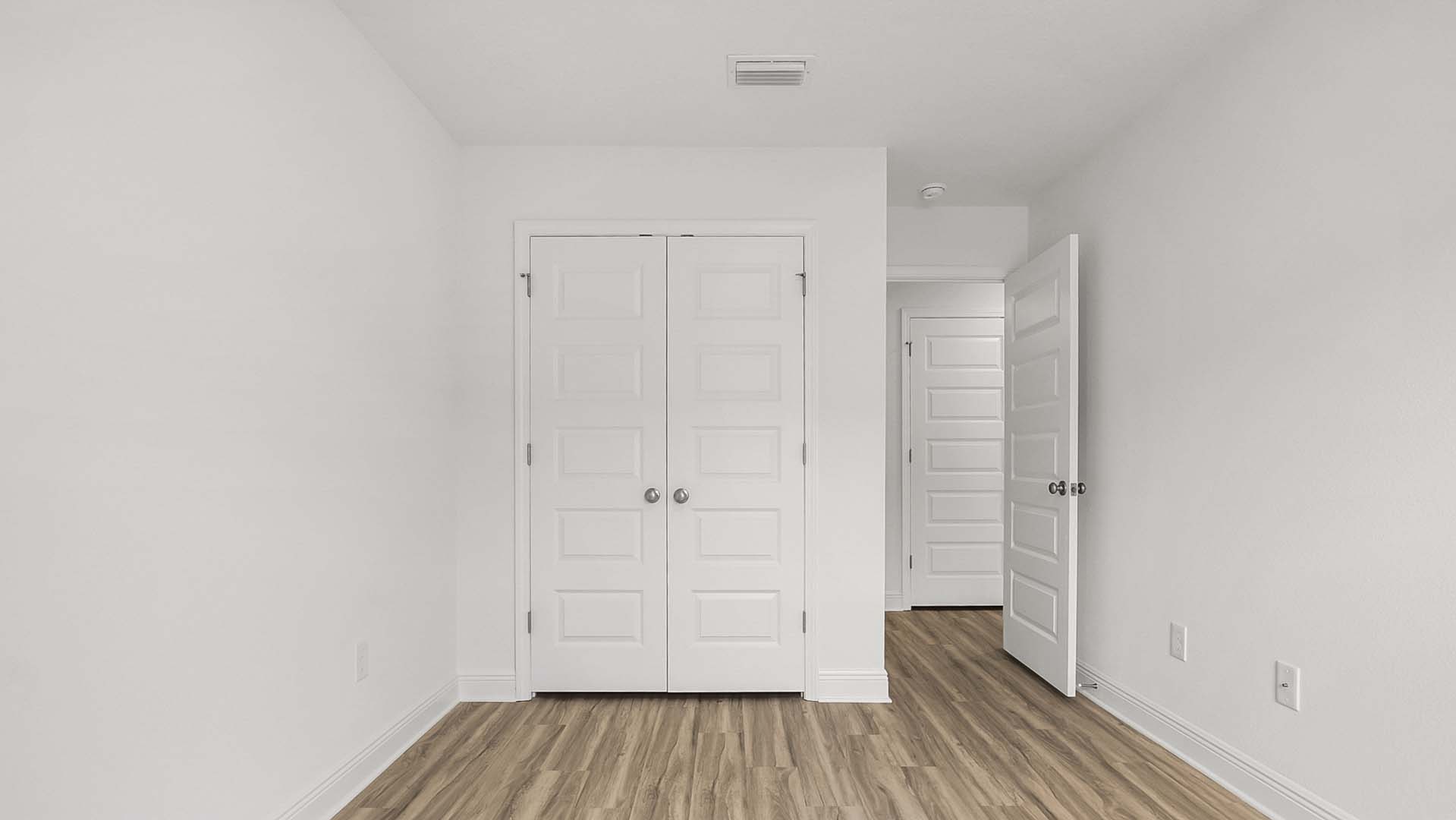 Guest bedroom one has EVP flooring and ample closet space