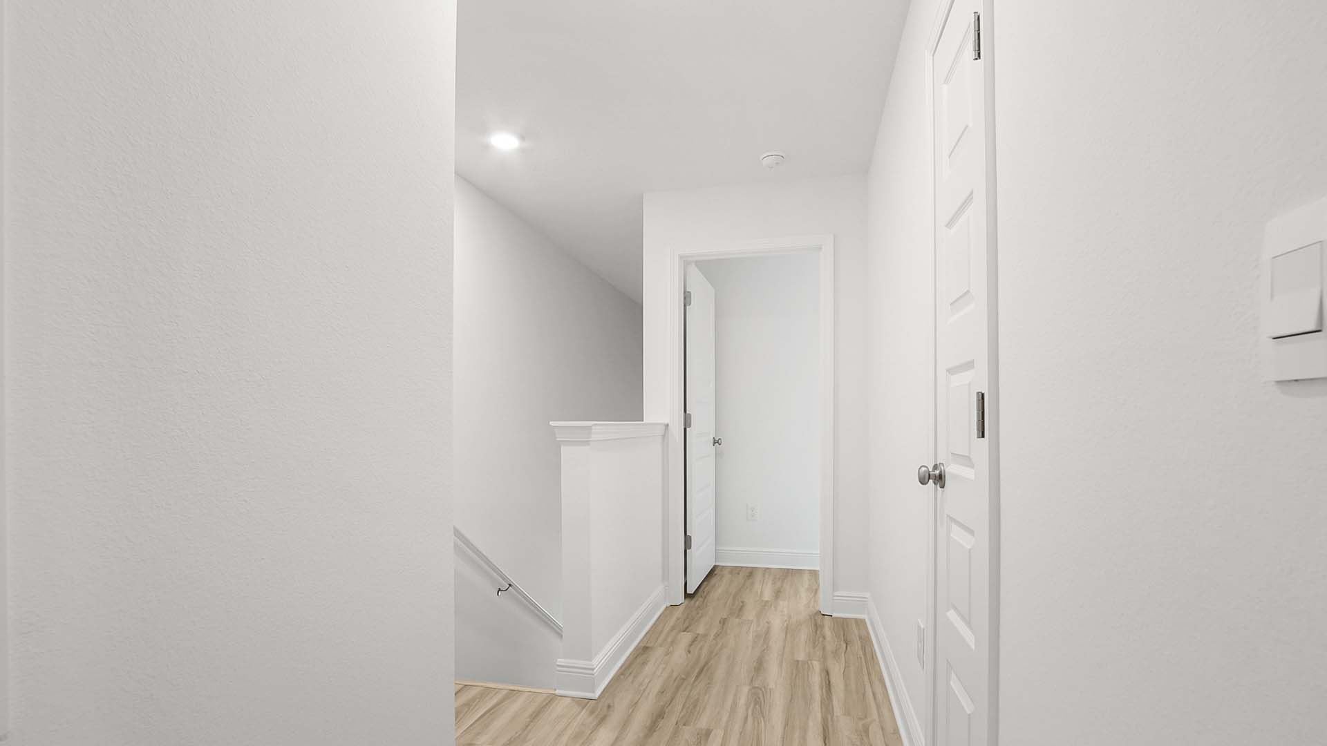 There is a hallway between the primary bedroom and guest bedrooms