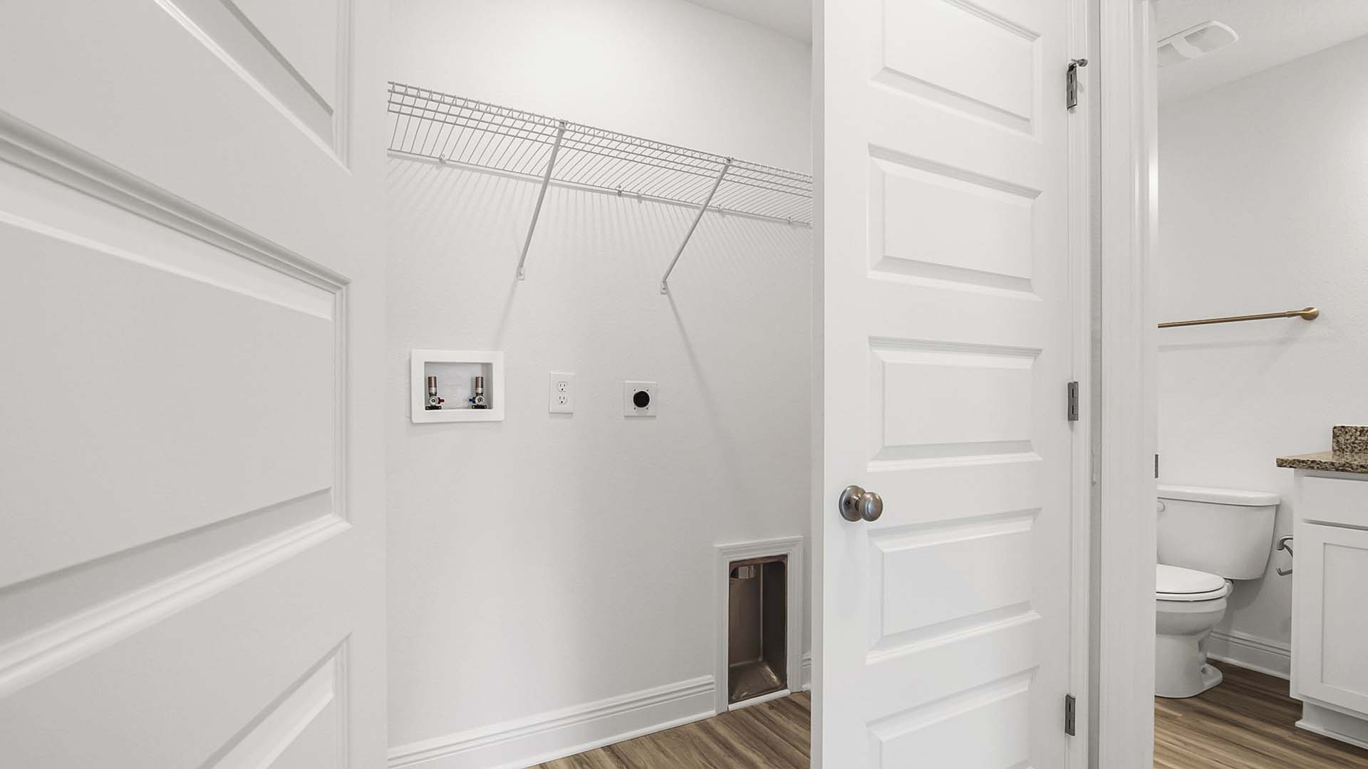 The laundry area is off the guest bedrooms enclosed with doors