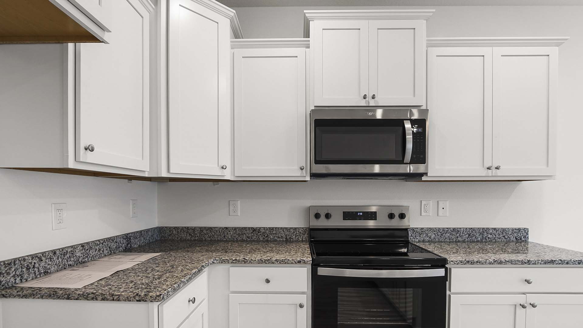 The kitchen has upper and lower cabinetry for storage