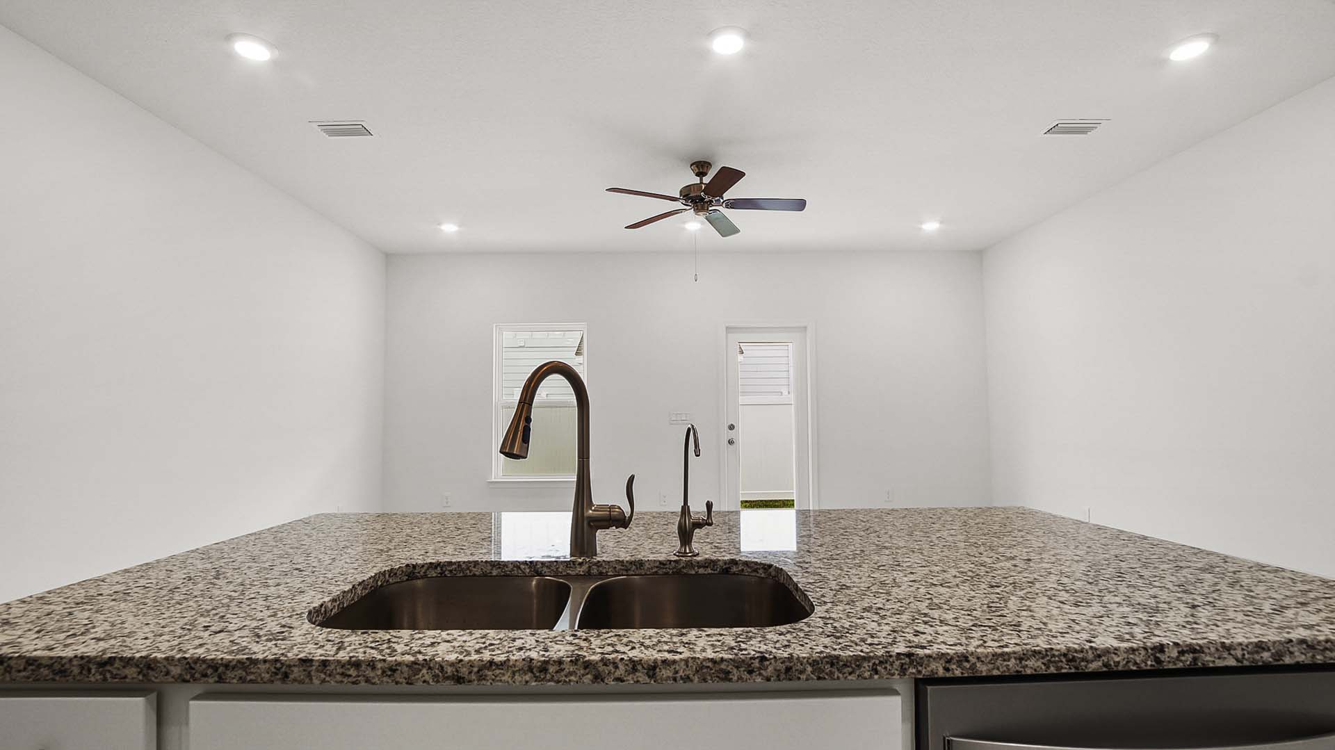 The kitchen island has granite counters