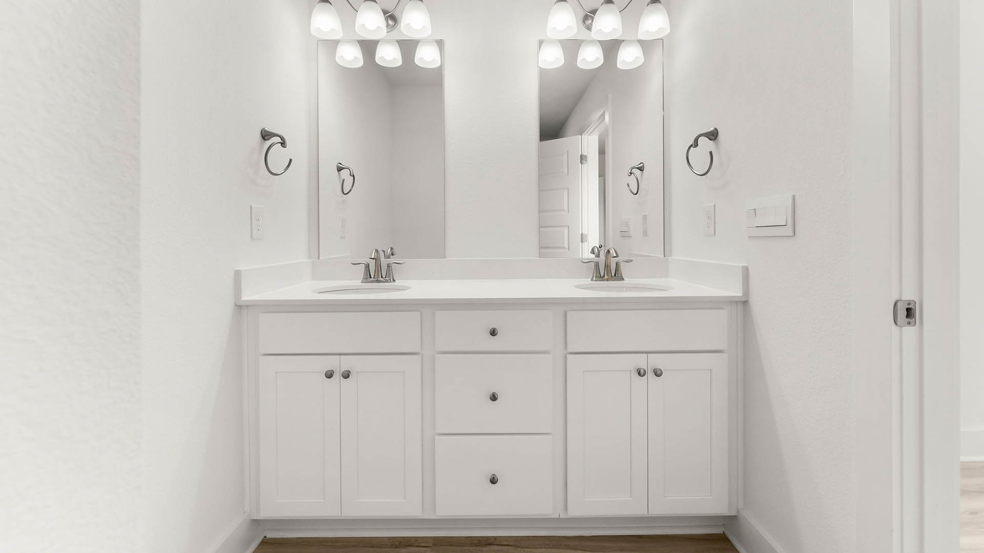 The primary bathroom has a dual sink vanity with lower cabinetry